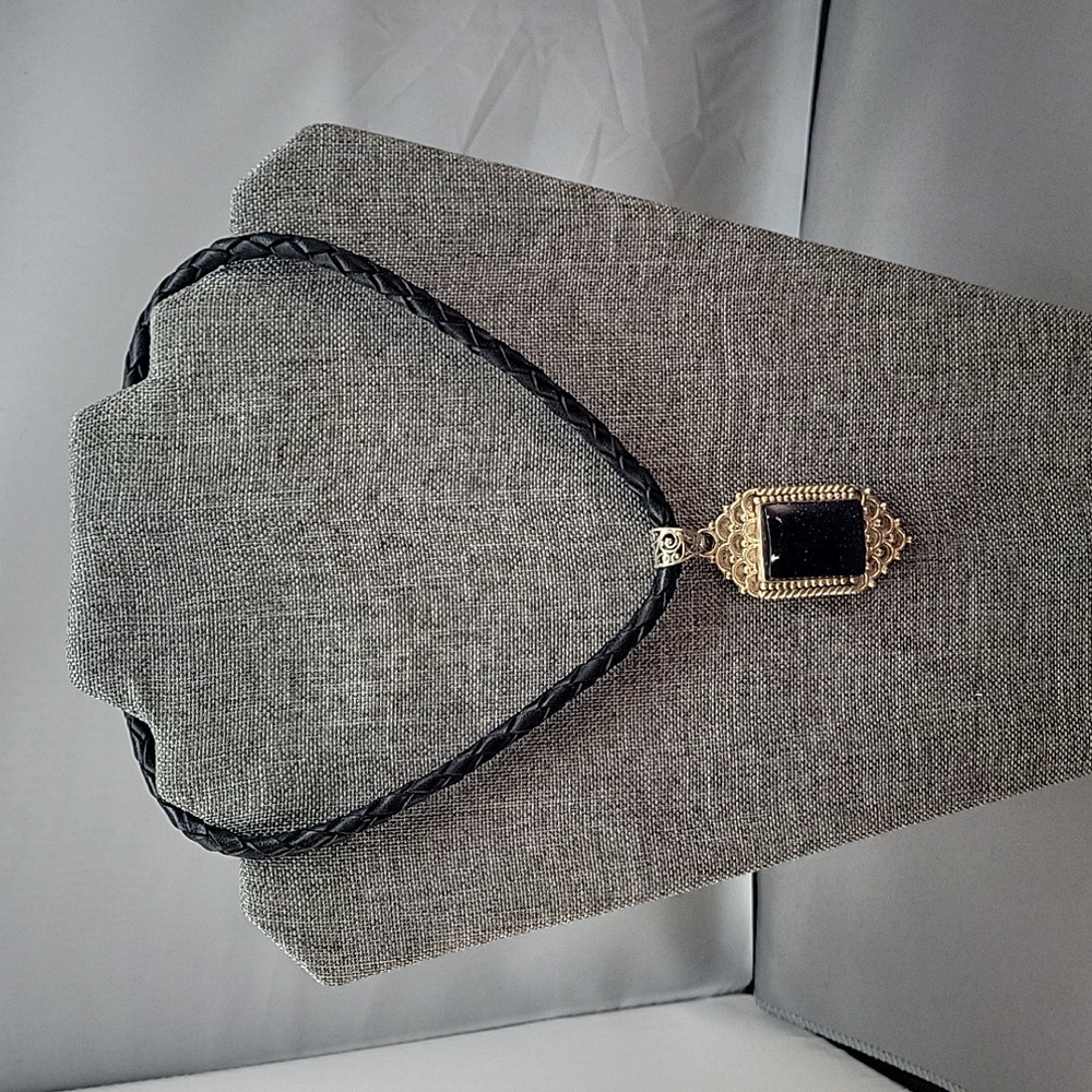 Pendant with black braided leather necklace